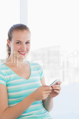 Portrait of a beautiful young woman text massaging