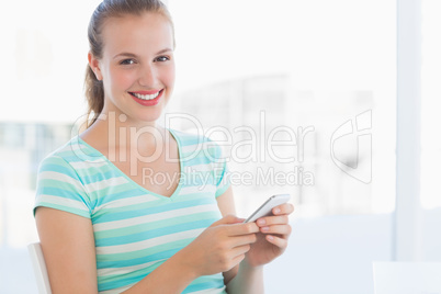 Portrait of a beautiful young woman text massaging