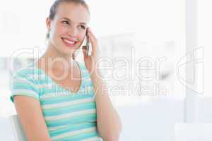 Beautiful young casual woman using mobile phone