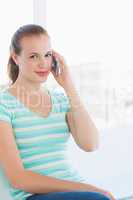 Portrait of a beautiful young casual woman using mobile phone