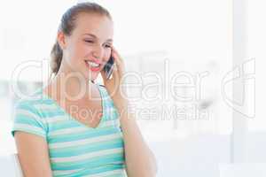 Beautiful young casual woman using mobile phone