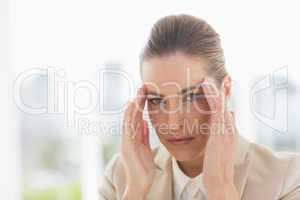 Close-up portrait of a young businesswoman with headache