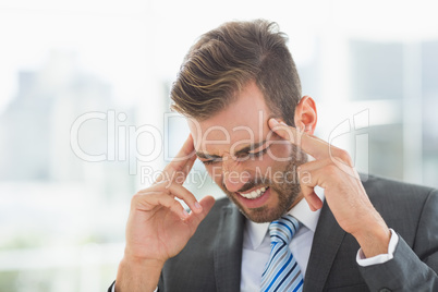 Close-up of a young businessman with headache