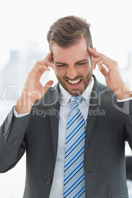 Close-up of a young businessman with headache