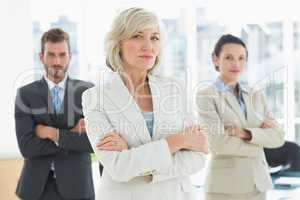 Confident business team with arms crossed in office