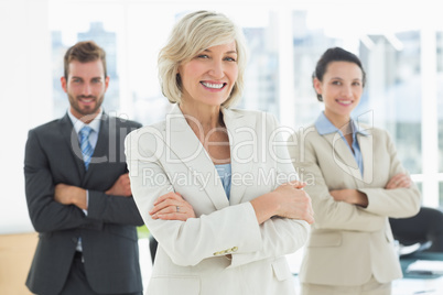 Confident business team with arms crossed in office