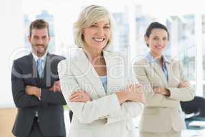 Confident business team with arms crossed in office