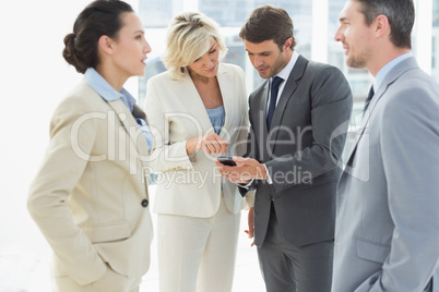 Business colleagues in discussion during office break