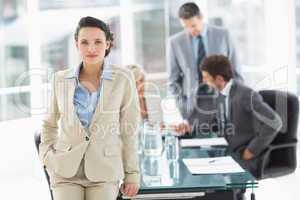 Businesswoman with colleagues discussing in office