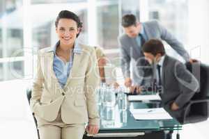Businesswoman with colleagues discussing in office