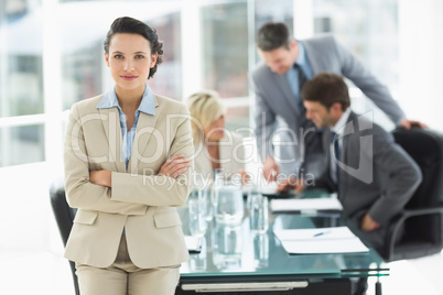 Businesswoman with colleagues discussing in office