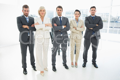 Confident business team with arms crossed in office