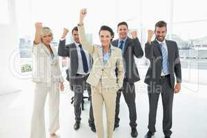 Successful business team clenching fists in office