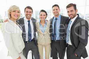 Confident business team standing together in office