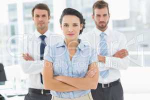 Confident business team with arms crossed in office