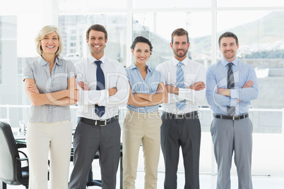 Confident business team with arms crossed in office