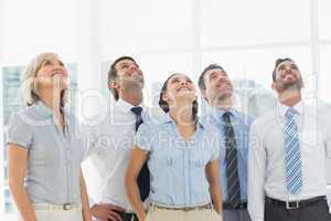 Business team looking up in office