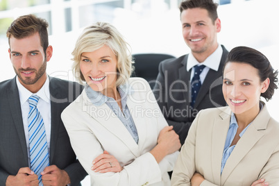 Confident business team with arms crossed in office