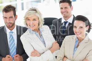 Confident business team with arms crossed in office