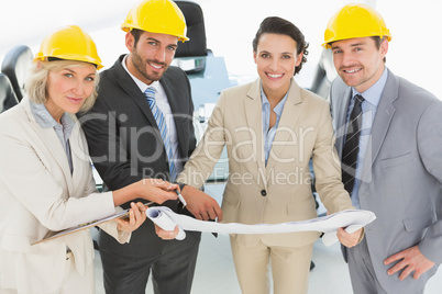 Well dressed architects with hard hats and blueprint