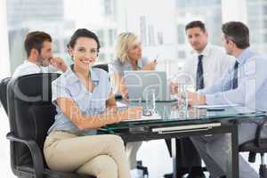 Young businesswoman with colleagues discussing in office