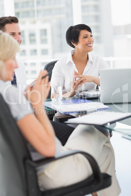 Well dressed business people in discussion at office