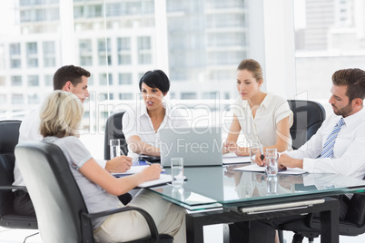 Well dressed business people in discussion at office