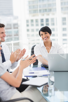 Business people clapping while in a meeting