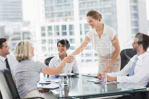 Executives shaking hands during a business meeting