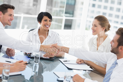 Executives shaking hands during a business meeting