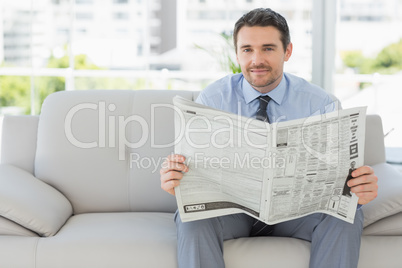 Portrait of a well dressed man reading newspaper