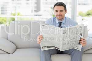 Portrait of a well dressed man reading newspaper