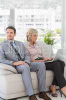 Well dressed man with woman using laptop at home