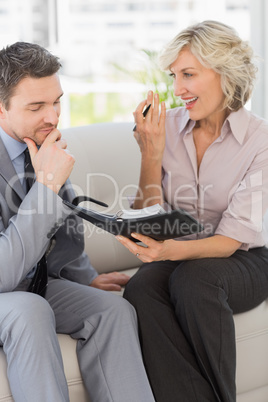 Businessman and his secretary  with diary at home