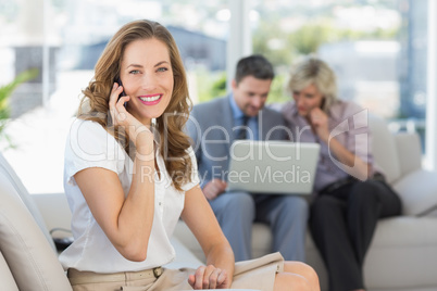 Businesswoman on call with colleagues using laptop