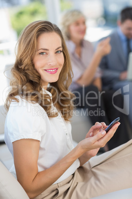 Businesswoman text messaging with colleagues using laptop Businesswoman text messaging with colleagues using laptop