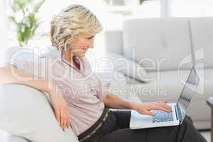 Beautiful businesswoman using laptop in the living room
