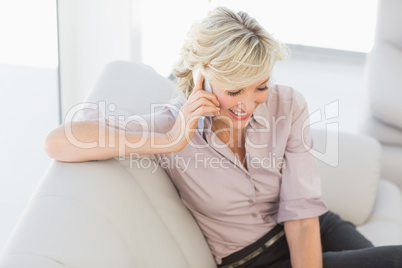 Beautiful businesswoman using mobile phone at home