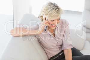 Beautiful businesswoman using mobile phone at home