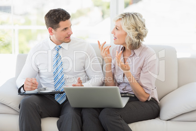 Businessman and his secretary with diary and laptop
