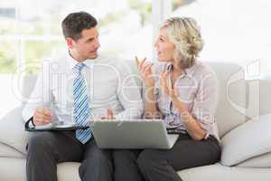 Businessman and his secretary with diary and laptop