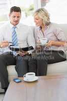 Businessman and his secretary  with diary and tea cup