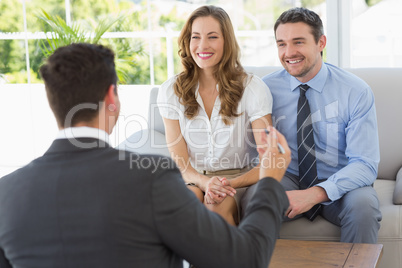 Smiling couple in meeting with a financial adviser