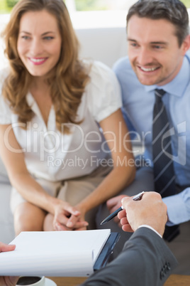 Smiling couple in meeting with a financial adviser