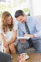 Smiling couple in meeting with a financial adviser