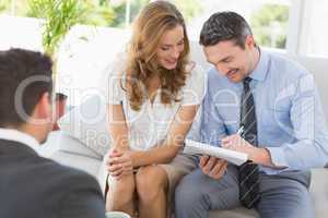 Smiling couple in meeting with a financial adviser