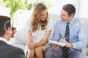 Smiling couple in meeting with a financial adviser