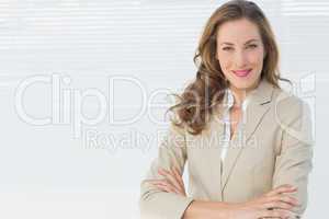 Portrait of a smiling businesswoman with arms crossed