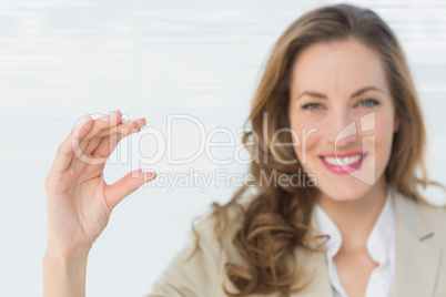 Smiling businesswoman holding blank card