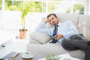 Well dressed man watching tv in the living room